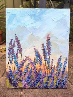 a painting of purple flowers on a canvas