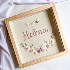 a frame with some flowers and butterflies on it