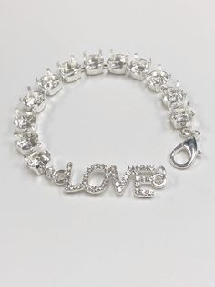 39ss/8.5mm Empty Cup Chain Love Charm Center Bracelet in Shiny Sterling Silver Plated.  Perfect for Bracelet Making.  12 settings  Love connector has clear rhinestones  Note:  Bracelet is approximately 7 inches.  Please contact me is you need the length adjusted  Just add your crystals and you're ready to wear or sell.  Crystals are not included.  **Please remember that sterling silver plated will tarnish like regular sterling.  Keep out of direct sunlight and clean as you would any other silver jewelry  When setting any crystals, you may need to shift your prongs out with your chain nose pliers, fit the crystal in, then fold your prongs over the crystals ** I cannot be responsible for damage to the settings as a result of the setting of the crystals either by a cupchain setting tool or pr Adjustable Stainless Steel Crystal Bracelet, Adjustable Nickel-free Crystal Bracelet For Party, Elegant Adjustable Crystal Bracelet, Nickel Free, Elegant Nickel-free Crystal Bracelet, Nickel-free Metal Chain Link Charm Bracelet, Empty Cup, Chain Nose Pliers, Bracelet Diy, Love Charms