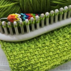 a close up of a toothbrush with yarn on it