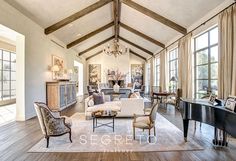 a living room filled with furniture and a grand piano