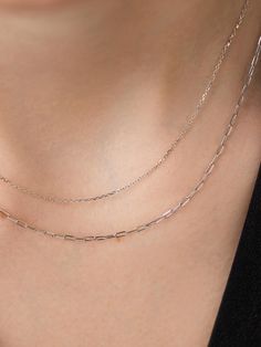 A stunning jewelry staple, this layered necklace is one you can wear over and over again. Crafted in shiny solid white gold, this timeless set features a dainty linked chain layered with a timeless paperclip chain for a look that’s made to last. Tarnish-free and always waterproof, you never have to take this set off. Pair this set with our White Gold Huggie Hoop Earrings to effortlessly round out your look. The Layered Necklace includes two pieces: White Gold Chain - White Gold Chain Necklace an White Gold Chain Necklace, Gold Huggie Hoop Earrings, Gold Layered Necklace, Jewelry Staples, Layered Necklace Set, White Gold Chains, Gold Necklace Layered, Huggie Hoop Earrings, Layered Necklace