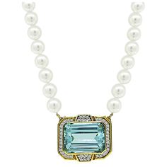 This is a gorgeous 18k yellow gold pearl pin / pendant necklace. The necklace is centered with a lovely emerald cut aquamarine that weighs approximately 35.00ct. The center stone is accentuated by sparkling round cut diamonds that weigh approximately 1.25ct. The color of these diamonds is H with VS clarity. The pendant measures 26.5mm by 30mm. The pearl strand measures 17 inches in length. The necklace weighs 65.4 grams. Aquamarine Jewelry Necklace, Pearl Pin, Pin Pendant, Aquamarine Jewelry, Pearl Strands, Gold Pearl, Round Cut Diamond, Aquamarine, Antique Jewelry