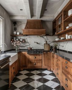 a kitchen with black and white checkered flooring, wooden cabinets and marble counter tops