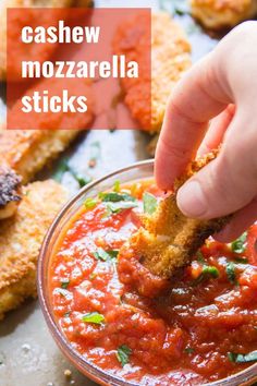 a person dipping some food into a small glass bowl with the words vegan mozzarella sticks in it