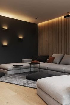 a living room filled with lots of furniture next to a wall mounted light above it