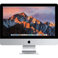 an apple desktop computer with mountains in the background