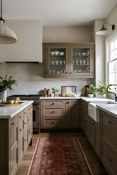 a kitchen with wooden cabinets and an area rug in front of the counter top that matches the cabinetry