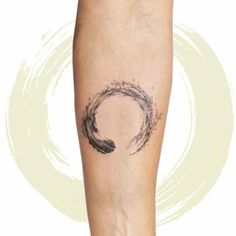 a woman's arm with a tattoo on it and a circle in the middle