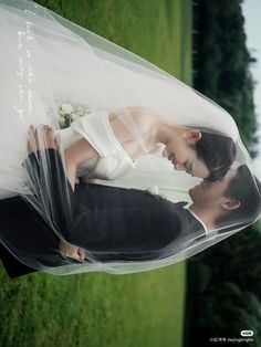 the bride and groom are posing for their wedding photo in front of some green grass