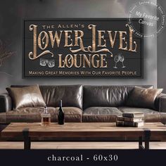 a couch and table in front of a wall with the words lower level lounge on it