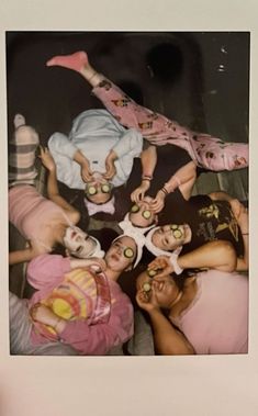 a group of people with their faces painted like clowns are posing for a photo