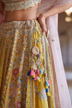 Editor's Note Hand Embroidered Panelled Lehenga Set With Zardosi Details And French Knots Fabric: Organza Color: Yellow Care: Dry Clean Only About the Designer A melange of rich embroideries, appliques, impeccable weaving, brilliant printing, and dyeing, Osaa by Adarsh is a story of India’s rich textile traditions replicated to form wedding couture. Adarsh Makharia saw the endless opportunities to engage the diverse artisans and designs and, with Osaa, weaved together a celebration of India’s he Osaa By Adarsh, Trending Lehenga Designs, Panelled Lehenga, Gold Organza, Blouse Yoke, Wedding Couture, Organza Lehenga, New Kurti, Endless Opportunities