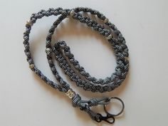 The Lanyard is woven with 550 7 strand paracord and intertwined with various style beads. Extending from the base are two loops with a silver swivel spring clip to hold your name badge or belongings and a split key ring for additional items such as keys, flash drives or glasses. Many, many uses: conference badge coworker gift flash drive holder and organizer id badge lanyard key card holder lanyard keychain lanyard nurse lanyard outdoor lanyard (hold knife, binoculars, flashlight, camera) pen or eyeglass holder physical education teacher lanyard security badge holder teacher lanyard Lanyard details 550 7 strand paracord Color: Black and White Beads: silver beads,  Length around the neck: 33 Base loops hanging down including clip: 3 cm (1.5 inches): these are adjustable to hang longer or sh Nurse Lanyard, Security Badge, Neck Lanyard, Paracord Beads, Keychain Lanyard, Paracord Keychain, Badge Lanyard, Teacher Lanyard, Lanyard Keychain