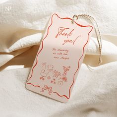 a thank you tag hanging on a white sheet