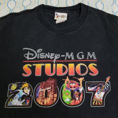 a black tshirt with the words disney - m g m studios on it