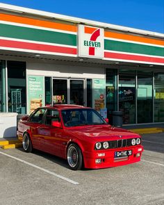 a red car parked in front of a store