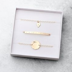 "A beautifully understated stacking bracelet set, featuring delicate, minimal shapes that can be personalised with a special message or date. Available in 14k gold fill and sterling silver. This set includes: + Skinny bar bracelet- max 25 characters. + Diamond tag bracelet - single character. + Hammered disc bracelet - single character. Each bracelet has a 1\" length of extender chain attached so that you can adjust the size for a perfect fit. So for example, if you choose the 6.5\" size, it wil Minimalist Hand Stamped Jewelry For Bridesmaids, Minimalist Personalized Bracelets For Best Friend Gift, Personalized Minimalist Name Bracelet For Bridesmaid, Minimalist Personalized Name Bracelet For Bridesmaid, Personalized Minimalist Name Bracelet As Best Friend Gift, Personalized Minimalist Name Bracelet Best Friend Gift, Minimalist Personalized Name Bracelet For Everyday, Personalized Minimalist Name Bracelet For Best Friend, Minimalist Sterling Silver Name Bracelet