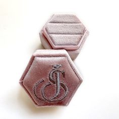 two pink hexagonal patches with an image of a person in a wheelchair on them