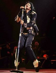 michael jackson performing on stage with his microphone