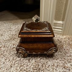 a wooden box sitting on top of a white carpet