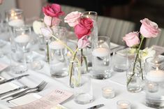 the table is set with candles, flowers and place settings for an elegant dinner party