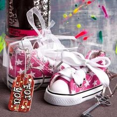 a pair of pink sneakers with white laces and bows are sitting on a table