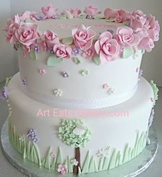 a three layer cake decorated with pink flowers