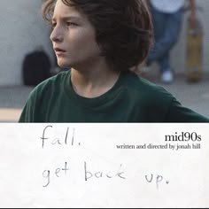 a young boy holding a sign that says fall, get back up with writing on it