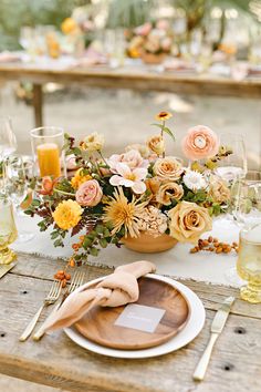 a table set with flowers and place settings