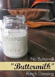 a glass jar filled with milk sitting on top of a wooden table