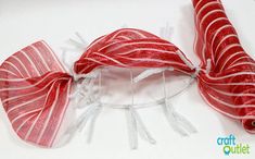 a red and white striped ribbon on top of a piece of string