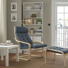 a living room with a chair and ottoman