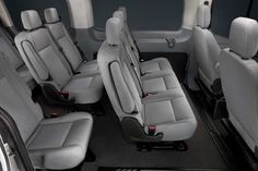 the interior of a vehicle with grey seats