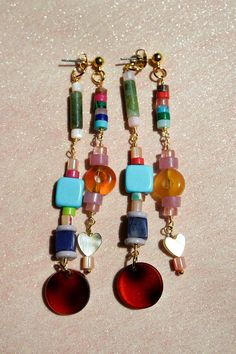 Get ready to have some fun with these playful, beaded ear jackets! Filled with bold colors, funky natural stones, and cute little details like hearts and tortoiseshell charms. On top of that these earrings are even cooler because they are like two in one! They will dangle in your ear in such a unique way. Whether you’re dressing up or keeping it casual, these earrings will add a pop of personality to any look. We created them in a rainbow color combination and in a fall inspired color palette wi Cozy Glam, Fall Tones, Hoop Charms, Stacked Earrings, Color Ways, Funky Earrings, Ear Jacket, Earrings Inspiration, Funky Jewelry