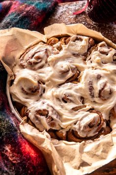 cinnamon rolls with icing in a pie pan