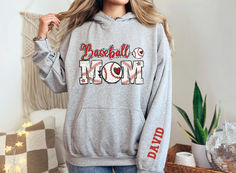 This customizable Baseball Mom hoodie comes in several colors and makes the perfect gift for mom! Casual Personalized Crew Neck Hoodie, Casual Personalized Cotton Hoodie, Casual Crew Neck Hoodie With Personalization, Casual Crew Neck Hoodie With Personalized Details, Casual Cotton Hoodie Personalized, Sporty Pre-shrunk Hoodie For Baseball Season, Long Sleeve Sports Hoodie For Baseball Season, Baseball Season Team Spirit Hoodie With Team Name, Baseball Season Fan Apparel Hoodie For Sports Events