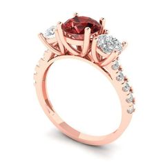 a rose gold engagement ring with three stones on the band and an oval shaped center stone