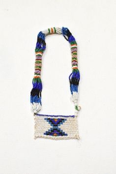 This is a beautiful Vintage Girls Love Letter Necklace from the Zulu tribe of South Africa. These kinds of Zulu love letters were made by young girls and women to express their emotions to their partners. The women made beads as gifts for friends or for admirers who had a leadership in their community such as chieftain and for daughters-in-laws. The bead work would be produced to show a sign of acceptance, welcome and building a mother-daughter relationship when their sons take a wife A very uni White Necklaces With Colorful Beads For Friendship, Bohemian Tiny Beads Necklace For Friendship, Bohemian Necklace With Tiny Beads For Friendship, Bohemian Rectangular Beaded Necklaces For Gifts, Rectangular Beaded Necklace With Large Beads For Gifts, White Beaded Necklaces For Friendship, Handmade Rectangular Beads For Gifts, Handmade Multicolor Necklace Souvenir, Festival Letter Beads