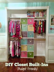 a closet filled with lots of clothes and boxes next to a wall mounted shelf that has pictures on it