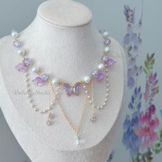 Step into a world of enchantment with our handmade Violet Fairy Blossom Choker Necklace, a magical accessory that captures the essence of fairy and princesscore aesthetics. Adorned with a stunning violet crystal butterfly centerpiece, surrounded by delicate glass beads and flowers, this necklace is designed to add a touch of whimsical charm to your look. 🌸 Key Features: Violet Crystal Butterfly: The centerpiece of this necklace is a captivating violet crystal butterfly, symbolizing transformati Fairy Jewelry Necklace, Purple Butterfly Necklace, Fairy Necklace Diy, Purple Necklace Aesthetic, Cute Bracelet Ideas Bead, Purple Fashion Aesthetic, Flower Necklace Aesthetic, Purple Beads Necklace, Violet Fairy