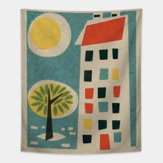 a wall hanging with an image of a house and tree