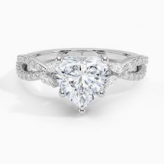 a heart shaped diamond engagement ring with twisted band and pave set diamonds on the sides