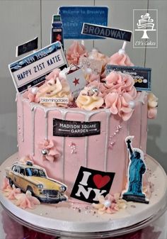 a cake decorated with pink frosting and pictures