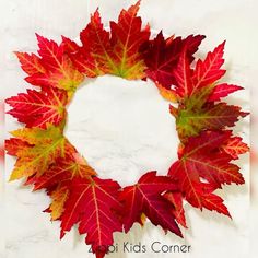 a wreath made out of red and yellow leaves on a white background with the words appi kids corner