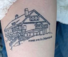 a tattoo on the arm of a person with a house and stairs behind it that says meet me in montauk