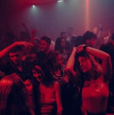 a group of people dancing in a club