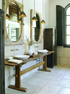 a bathroom with two sinks and mirrors on the wall