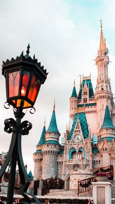 a street light in front of a castle