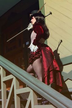 a woman dressed in costume walking down some stairs